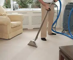 Carpet cleaning professional removing dirt and stains with a hot-water extraction tool in a home, New Haven, CT.
